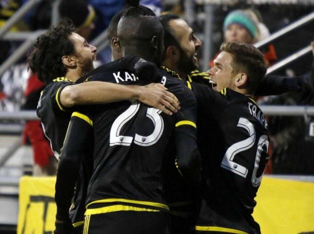 Columbus Crew team members forward Kei Kamara (23), midfielder Justin Meram (9) and midfielder Wil Trapp (20) celebrate Meram's goal with other members against the New York Red Bulls during the first half in the first leg of the MLS soccer Eastern Conference championship in Columbus, Ohio, Sunday, Nov. 22, 2015. (AP Photo/Paul Vernon)