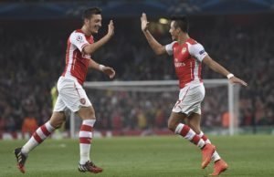 Arsenal's Alexis Sanchez, right, celebrates after scoring against Galatasaray with his teammate Mesut Ozil during the Champions League Group D soccer match between Arsenal  and Galatasaray , at the Emirates Stadium in London, on Wednesday, Oct 1, 2014. (AP Photo/ Tim Ireland)